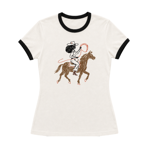 Black woman wearing Fros & Spurs vintage white Black cowgirl Western ringer tee with denim shorts.