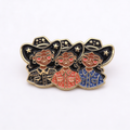 Enamel pin with 3 Black cowgirls wearing cowboy hats on a white background