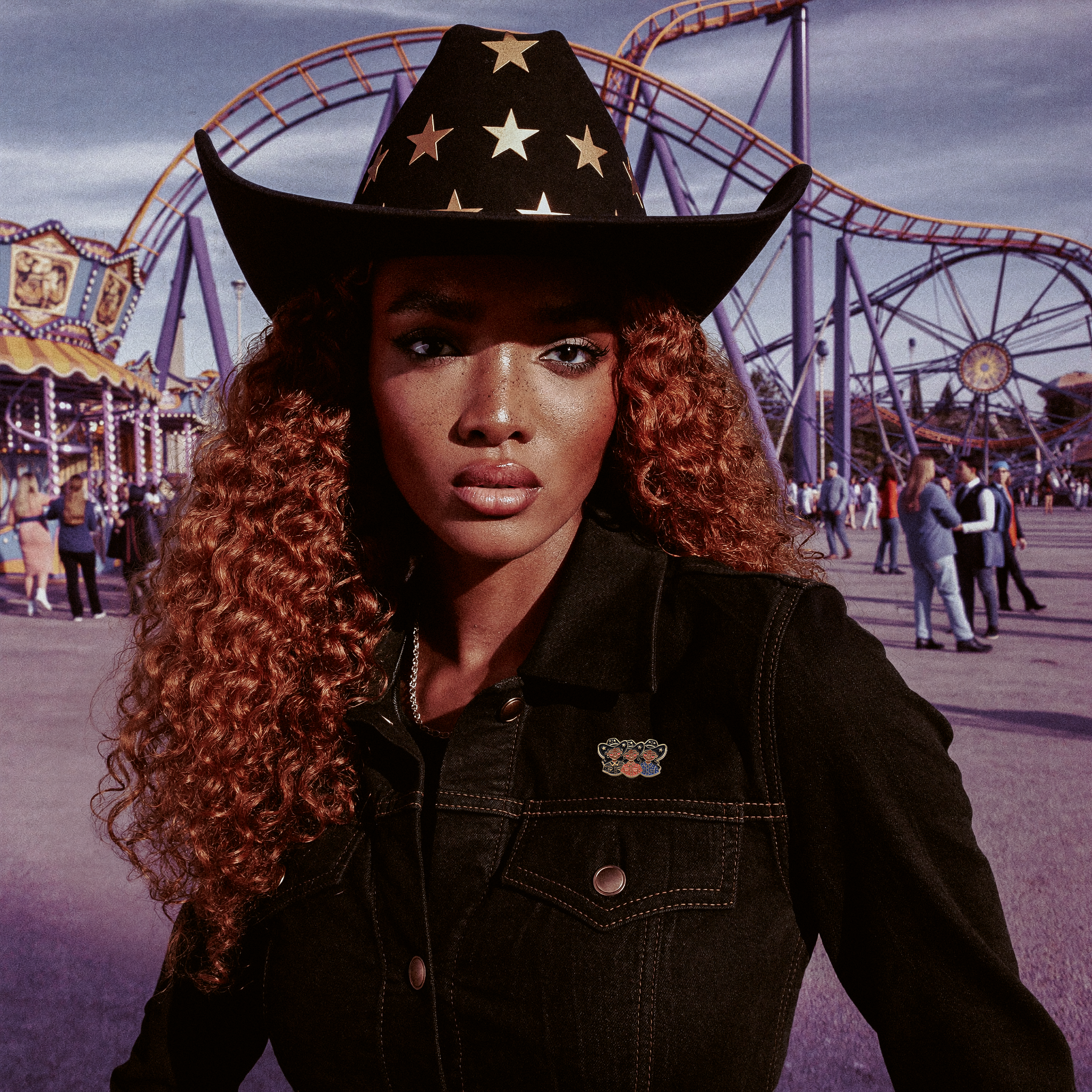 Black cowgirl wearing enamel pin in an amusement park 